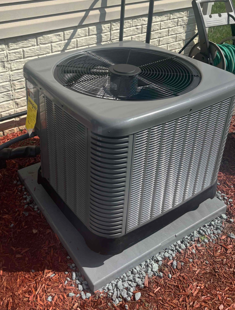 Air conditioning condenser unit outside of house