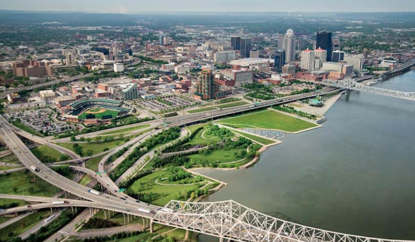 Front entrance of Louisville HVAC office with company trucks nearby