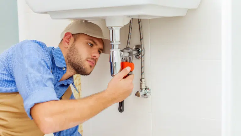 Plumber working on pipes